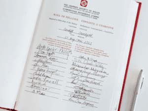 A page from the Learned Society of Wales Roll of Fellows with multiple signatures.