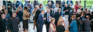 A large crowd of people at a reception at the Royal Welsh College of Music and Drama