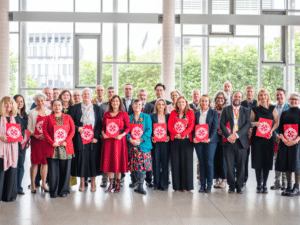Several dozen new Fellows of the Learned Society of Wales standing in a group looking directly at the camera.